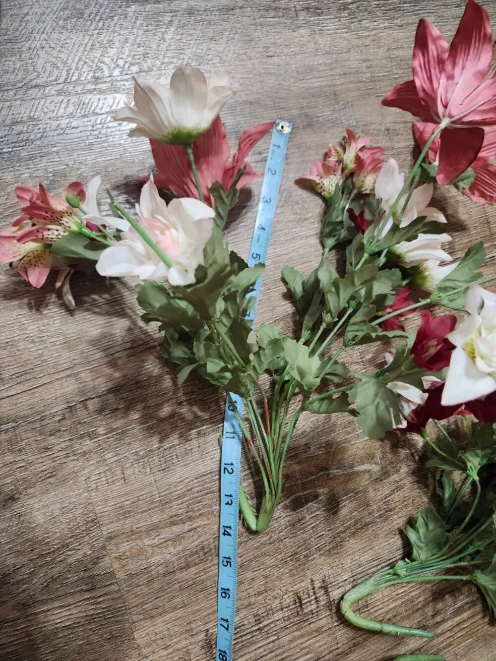 vintage floral arrangement of artificial flowers in small vase